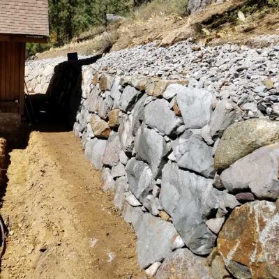 How do you excavate and build a retaining wall